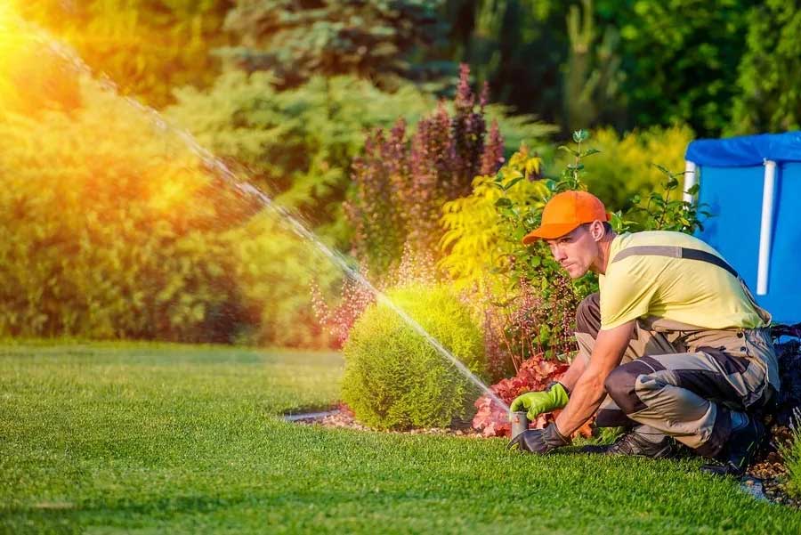 technician activating a residential irrigation system, start-up & inspect